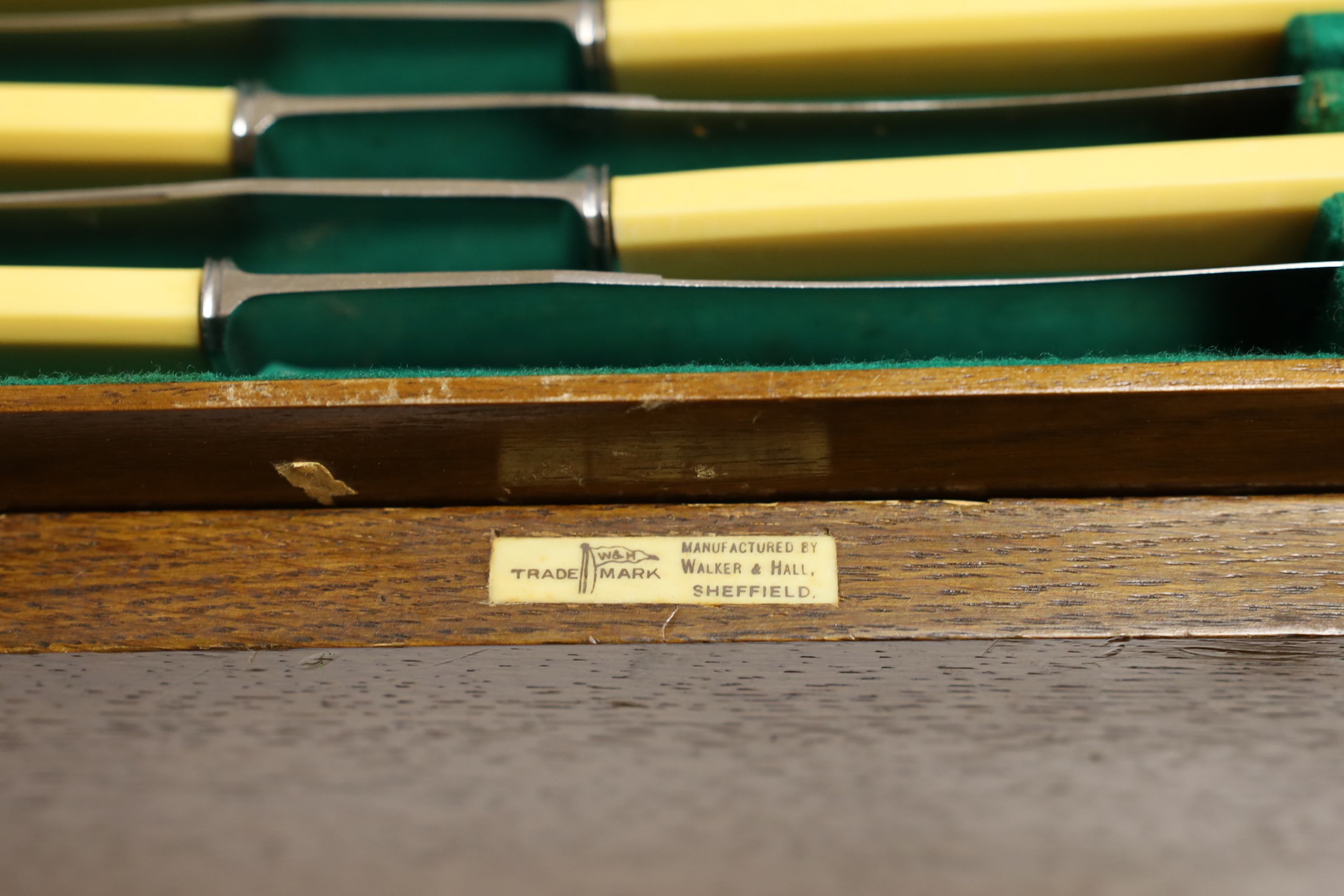 An almost complete George VI Art Deco silver canteen of cutlery by Walker & Hall comprising seventy five items, 119.6oz, together with eleven ivorine handled table knives and twelve dessert knives (two with replaced hand